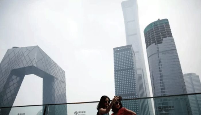 Women pose for pictures in Beijing's central business district (CBD), China || Reuters File Photo: Collected  