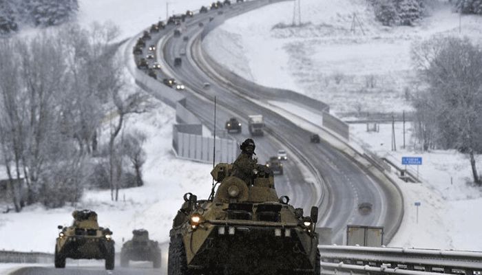 FILE - A convoy of Russian armored vehicles moves along a highway in Crimea, Tuesday, Jan. 18, 2022. With tens of thousands of Russian troops positioned near Ukraine, the Kremlin has kept the U.S. and its allies guessing about its next moves in the worst Russia-West security crisis since the Cold War. || AP Photo: Collected  