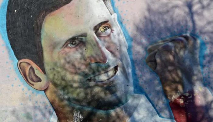 A mural depicting Serbian tennis player Novak Djokovic is seen on the side of a building in Belgrade on January 16, 2022. || AFP Photo: Collected  
