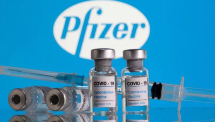 Vials labelled ‘COVID-19 Coronavirus Vaccine’ and a syringe are seen in front of the Pfizer logo in this illustration taken February 9, 2021 || Reuters Photo: Collected  