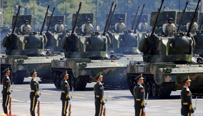 China's People's Liberation Army (PLA) soldiers on their armoured vehicles equipped with anti-aircraft artillery roll to Tiananmen Square during the military parade marking the 70th anniversary of the end of World War Two, in Beijing, China, September 3, 2015 || Reuters Photo: Collected  