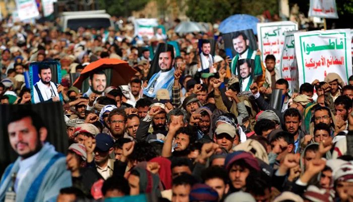 Supporter of Yemen's Huthis raise portraits of the rebels' leader Abdul-Malik al-Huthi, during a rally marking the seventh anniversary of the Saudi-led coalition's intervention in their country, in the capital Sanaa, on March 26, 2022 || AFP Photo: Collected  