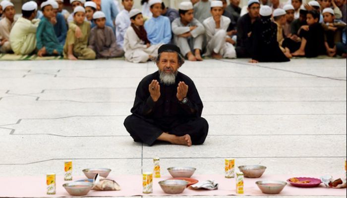 An old man prays before Iftar at a mosque in Peshawar, Pakistan.