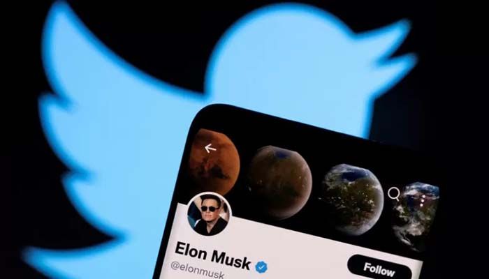 File photo shows Elon Musk's Twitter account on a smartphone in front of the Twitter logo || Reuters Photo: Collected  