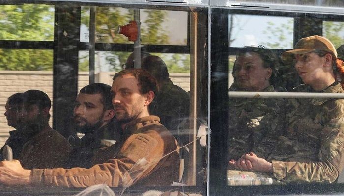 A bus carrying service members of the Ukrainian armed forces, who surrendered at the besieged Azovstal steel mill, drives away under escort of the pro-Russian military in the course of Ukraine-Russia conflict in Mariupol, Ukraine May 20, 2022. REUTERS