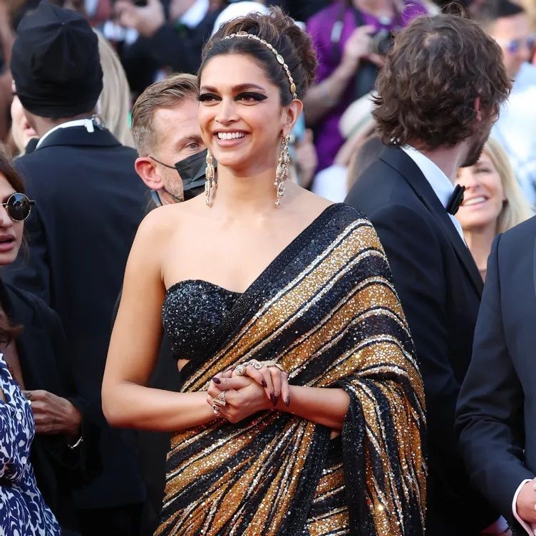 Deepika Padukone made her first red carpet appearance dressed in a black and gold saree.