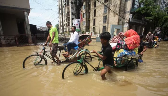 File photo shows rickshaw pullers transporting customers along a flooded street following heavy rainfalls in Sylhet || AFP Photo: Collected  