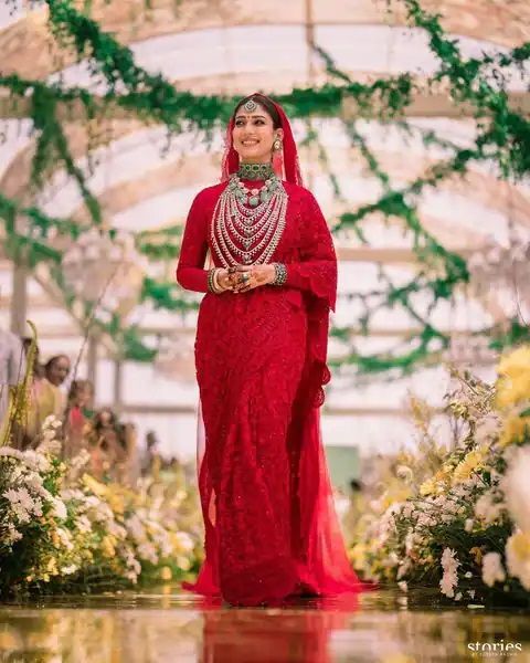 South stunner Nayanthara looked ethereal on her wedding day in a cherry red saree and heavy jewells.