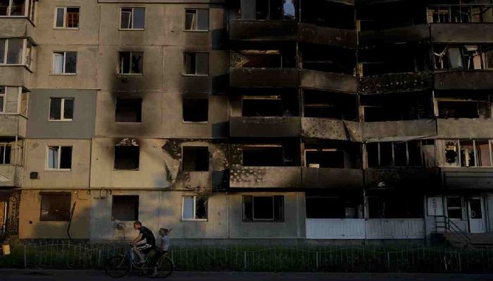 A man rides a bicycle in front of a building destroyed by attacks in Borodyanka, on the outskirts of Kyiv, Ukraine, Sunday, June 12, 2022 || AP Photo
