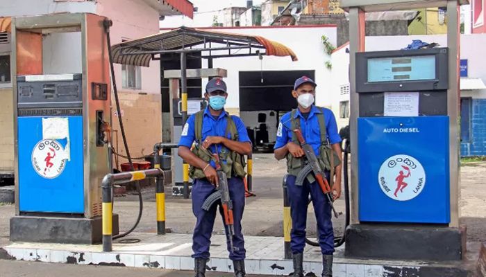 Navy officers stand guard at a closed fuel station in Colombo on June 12, 2022 || AFP Photo