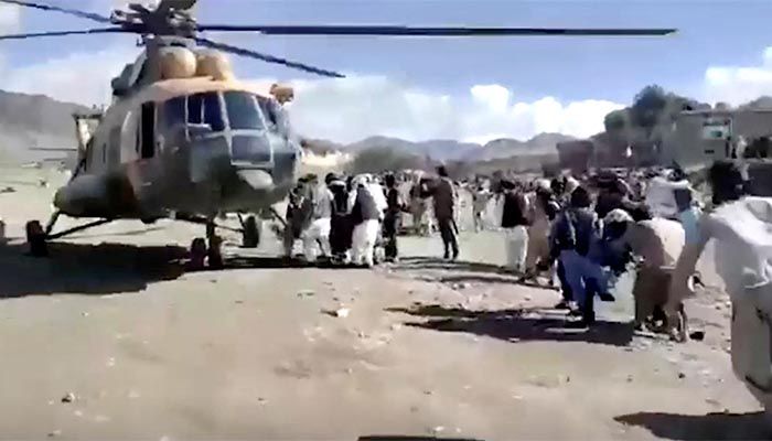 People carry injured to a helicopter following a massive earthquake, in Paktika Province, Afghanistan, June 22, 2022, in this screen grab taken from a video || Photo: REUTERS