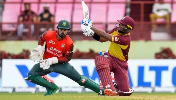 Nicholas Pooran hits 6 and Quazi Nurul Hasan Sohan attempts to take catch during the third and final T20 International match between West Indies and Bangladesh at Guyana National Stadium in Providence, Guyana, on July 7, 2022 || AFP Photo