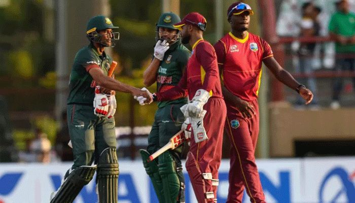 Mahmudullah (L) and Quazi Nurul Hasan Sohan (2L) of Bangladesh being congratulated by Shai Hope (2R) and Jayden Seales (R) of West Indies after winning the first ODI match between West Indies and Bangladesh at Guyana National Stadium in Providence, Guyana on July 10, 2022 || AFP Photo