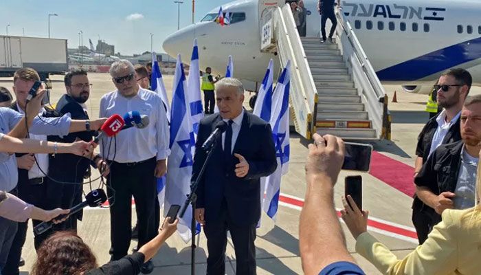 Israel's Prime Minister Yair Lapid speaks to the press ahead of boarding his flight to France, at Israel's Ben Gurion Airport in Lod on July 5, 2022 || AFP Photo
