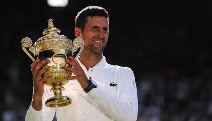 Serbia's Novak Djokovic poses with his trophy after defeating Australia's Nick Kyrgios during the men's singles final tennis match on the fourteenth day of the 2022 Wimbledon Championships at The All England Tennis Club in Wimbledon, southwest London, on July 10, 2022 || AFP Photo