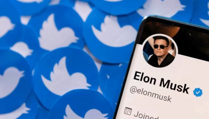 Elon Musk's Twitter profile is seen on a smartphone placed on printed Twitter logos in this picture illustration taken on April 28, 2022 || Reuters Photo
