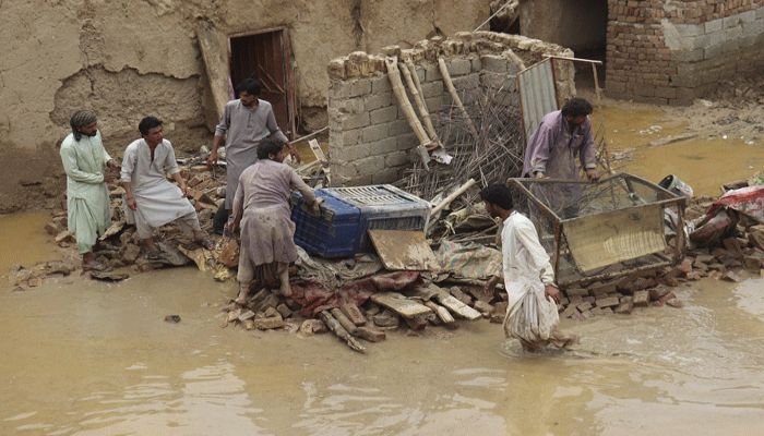 Residents clear debris of a damaged house due to a heavy monsoon rainfall on the outskirts of Quetta on July 5, 2022 || AFP Photo: Collected 