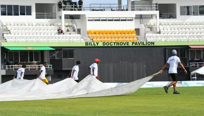 Ground staff bring out the covers as rain stopped play during the first T20I between West Indies and Bangladesh at Windsor Park in Roseau, Dominica, on July 02, 2022. || AFP Photo