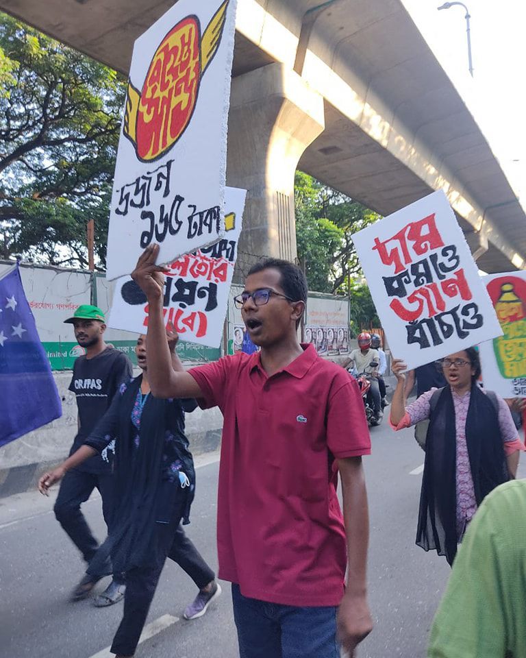 Activists in the hartal march with placards.