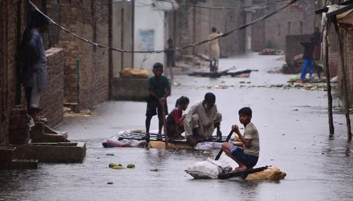 Residents use rafts to make their way along a waterlogged street in a residential area after a heavy monsoon rainfall in Hyderabad, Pakistan on August 24, 2022 || AFP Photo 