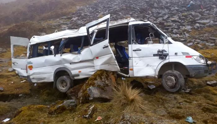 A handout picture released by the Peruvian Police on August 22, 2022, shows a minibus that fell into an abyss due to heavy fog conditions on a country route at the Abra Málaga, Peru || AFP Photo: Collected  