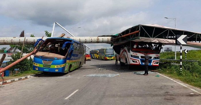 A huge billboard collapsed on top of two buses in the rampage of Sitrang in Faridpur. At that time the driver and helpers inside the bus were rescued by local people.