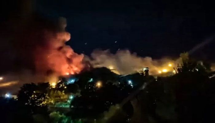 This image grab from a UGC video made available on October 15, 2022, reportedly shows flames and thick smoke rising from the Evin prison, in the northwest of the Iranian capital Tehran. || AFP Photo