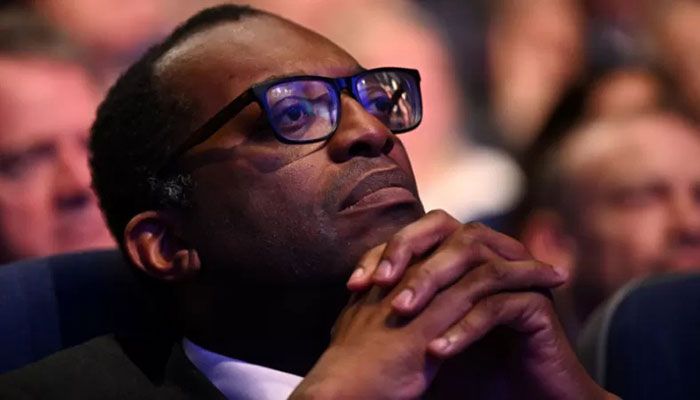 Britain's Chancellor of the Exchequer Kwasi Kwarteng listens as Britain's Prime Minister Liz Truss (unseen) delivers her keynote address on the final day of the annual Conservative Party Conference in Birmingham, central England, on October 5, 2022 || AFP Photo