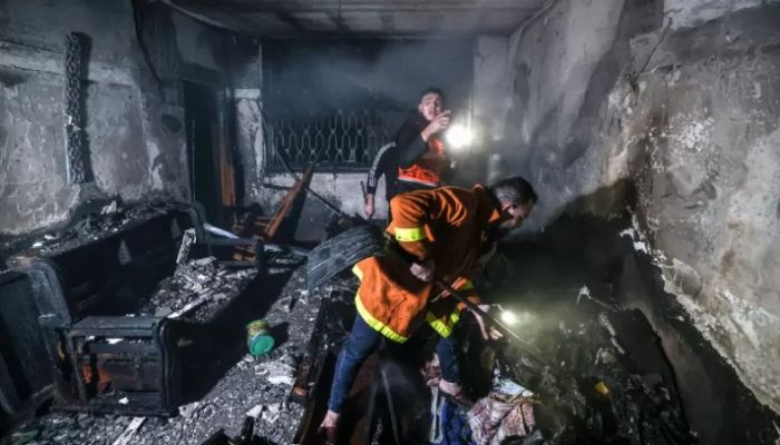 Palestinian firefighters extinguish flames in an apartment ravaged by fire in the Jabalia refugee camp in the northern Gaza strip on November 17, 2022 — AFP Photo 