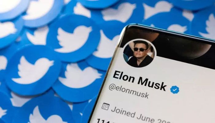 Elon Musk's Twitter profile is seen on a smartphone placed on printed Twitter logos in this picture illustration taken April 28, 2022 || Reuters Photo: Collected  