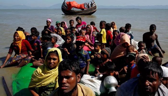 Rohingya refugees sit on a makeshift boat as they get interrogated by the Border Guard Bangladesh after crossing the Bangladesh-Myanmar border, at Shah Porir Dwip near Cox's Bazar, Bangladesh on November 9, 2017 || Reuters Photo