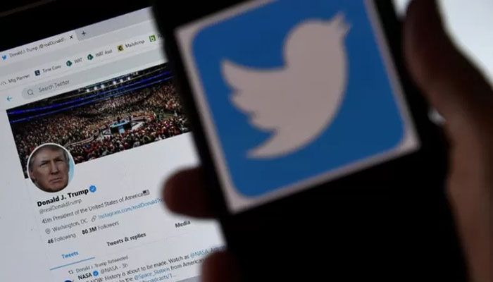 A Twitter logo is displayed on a mobile phone with former president Trump's Twitter page shown in the background on May 27, 2020, in Arlington, Virginia || AFP Photo