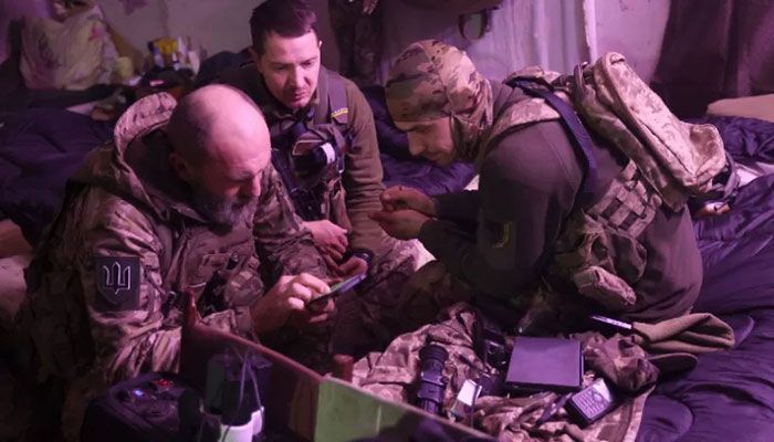 Ukrainian servicemen sit in a hideout on the frontline of the Donetsk region on November 21, 2022, amid the Russian invasion of Ukraine. || AFP Photo