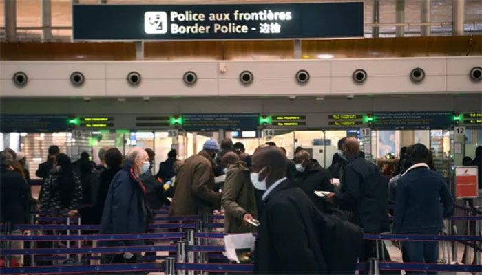 In this file photo taken on February 1, 2021, travellers queue at the immigration desk of Roissy Charles-de-Gaulle international airport, as new Covid-19 border restrictions come into effect || AFP Photo