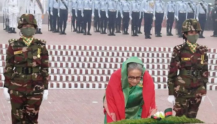 Prime Minister Sheikh Hasina places a wreath at the National Memorial in capital's Savar on Friday morning, marking the 52nd Victory Day || BSS Photo