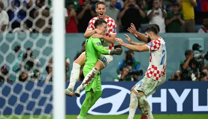 Croatia's goalkeeper Dominik Livakovic celebrates with teammates after their victory in the Qatar 2022 World Cup round of 16 football match between Japan and Croatia at the Al-Janoub Stadium in Al-Wakrah, south of Doha, on December 5, 2022 || AFP Photo: Collected  