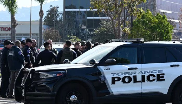 Torrance police officers and other law enforcement gather after breaking into a van with a body in the driver's seat in Torrance, California, on January 22, 2023 || AFP Photo