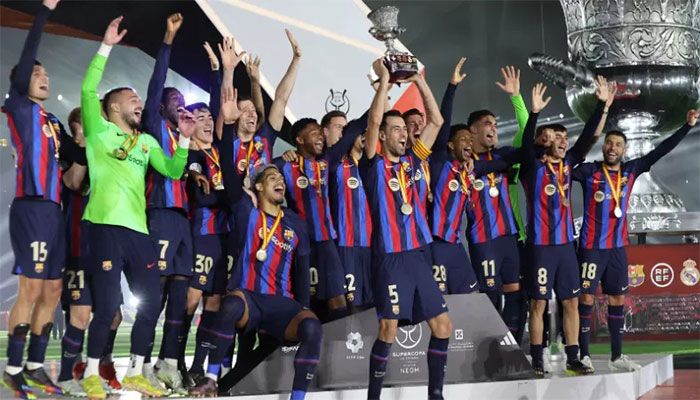 Barcelona's players celebrate on the podium after winning the Spanish Super Cup final football match between Real Madrid CF and FC Barcelona at the King Fahd International Stadium in Riyadh, Saudi Arabia, on January 15, 2023 || AFP Photo