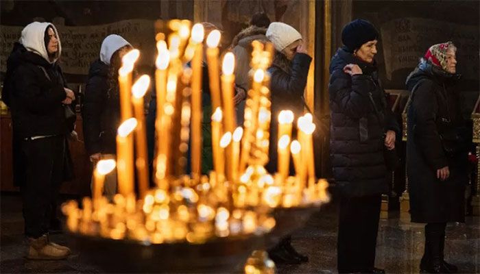 Worshippers pray during an Orthodox Christmas service at the St Michael's Golden-Domed Monastery in Kyiv on January 7, 2023, amid the Russian invasion of Ukraine. || AFP Photo