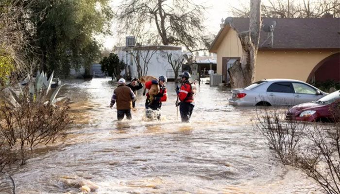 San Diego firefighters rescue dogs from a flooded home in Merced, California, on January 10, 2023 || AFP Photo 