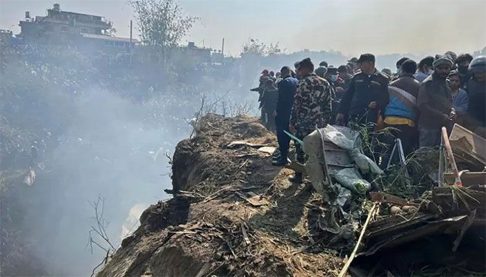 Rescuers and onlookers gather at the site of a plane crash in Pokhara on January 15, 2023 || AFP Photo