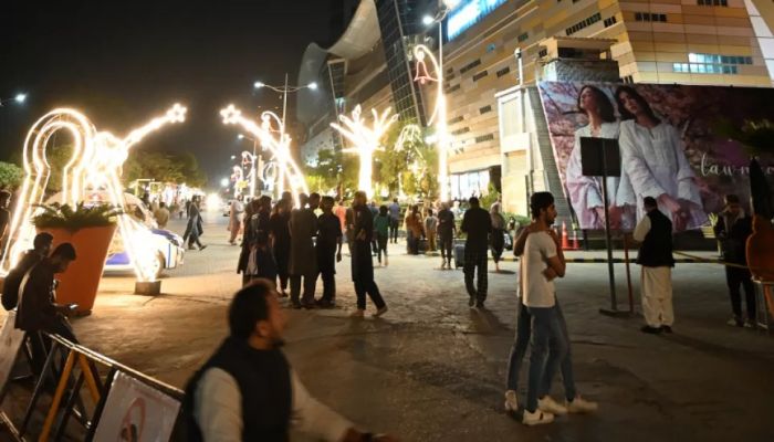 People gather outside a mall following an earthquake in Islamabad on March 21, 2023 || AFP Photo