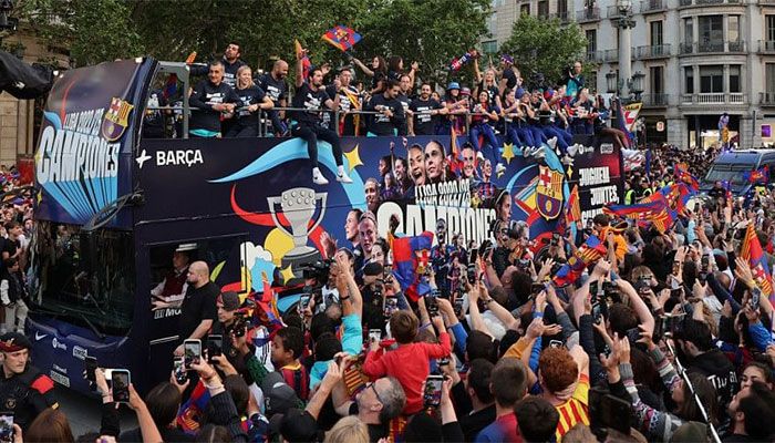 Barca Fans Celebrate League Titles with Players in Parade