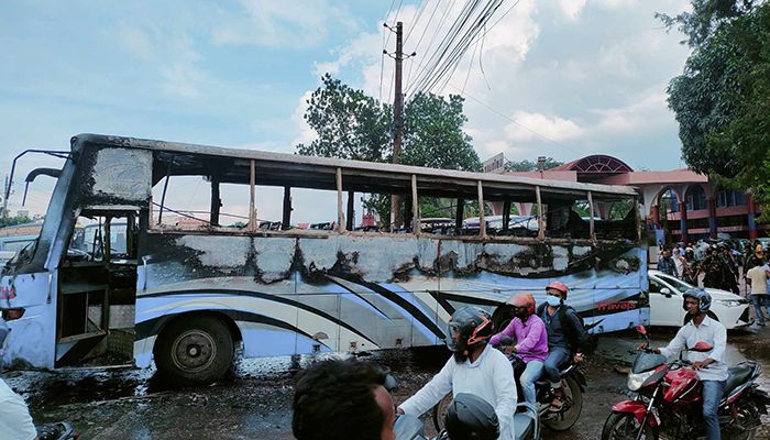BNP activists set fire to a parked bus near a fuel refilling station at Matuail in Dhaka, on Saturday || Photo: Shampratik Deshkal