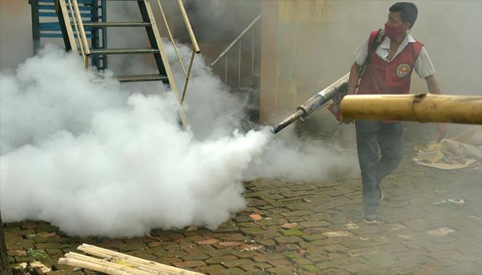 A worker sprays anti-mosquito fog to try to stop the dengue virus from spreading through Dhaka.