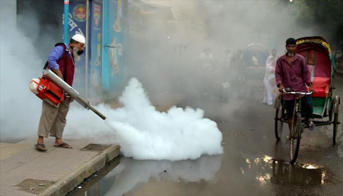 A worker sprays anti-mosquito fog in an effort to contain the spread of dengue in Dhaka.