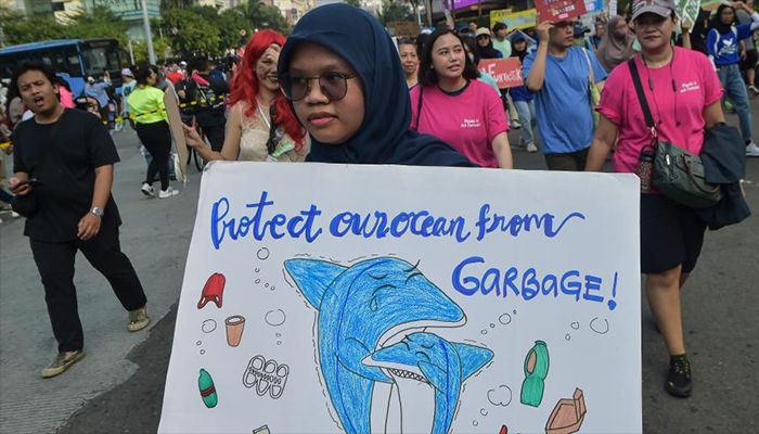 A child protester marches at the plastic free parade at Sudirman Street in Jakarta, Indonesia on July 30, 2023.