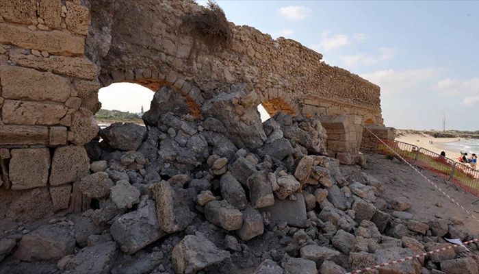 The collapsed arch of the Roman aqueduct system on a beach in Caesarea, Israel. An ancient arch structure in Caesarea's famous ancient Roman aqueduct system collapsed on a beach early Friday morning. Israel Antiquities Authority said the section that collapsed was built in the time of Emperor Hadrian, some 1900 years ago. 