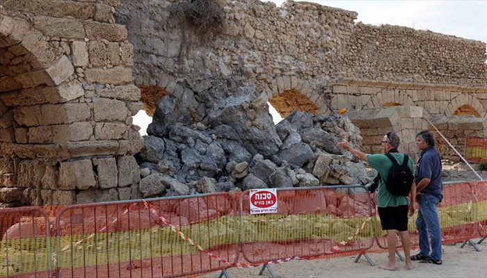 The collapsed arch of the Roman aqueduct system on a beach in Caesarea, Israel. An ancient arch structure in Caesarea's famous ancient Roman aqueduct system collapsed on a beach early Friday morning. Israel Antiquities Authority said the section that collapsed was built in the time of Emperor Hadrian, some 1900 years ago.