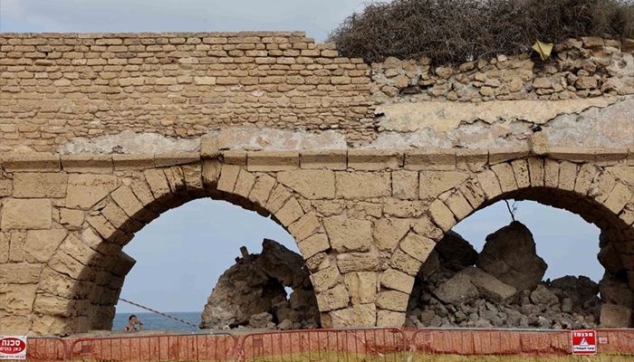 The collapsed arch of the Roman aqueduct system on a beach in Caesarea, Israel. An ancient arch structure in Caesarea's famous ancient Roman aqueduct system collapsed on a beach early Friday morning. Israel Antiquities Authority said the section that collapsed was built in the time of Emperor Hadrian, some 1900 years ago.